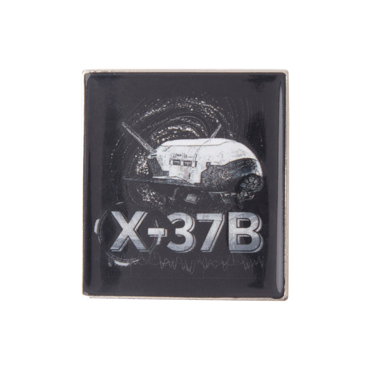Boeing X-37B Orbital Test Vehicle Graphic Lapel Pin featuring a square illustration of the spacecraft against a dark, swirling background.