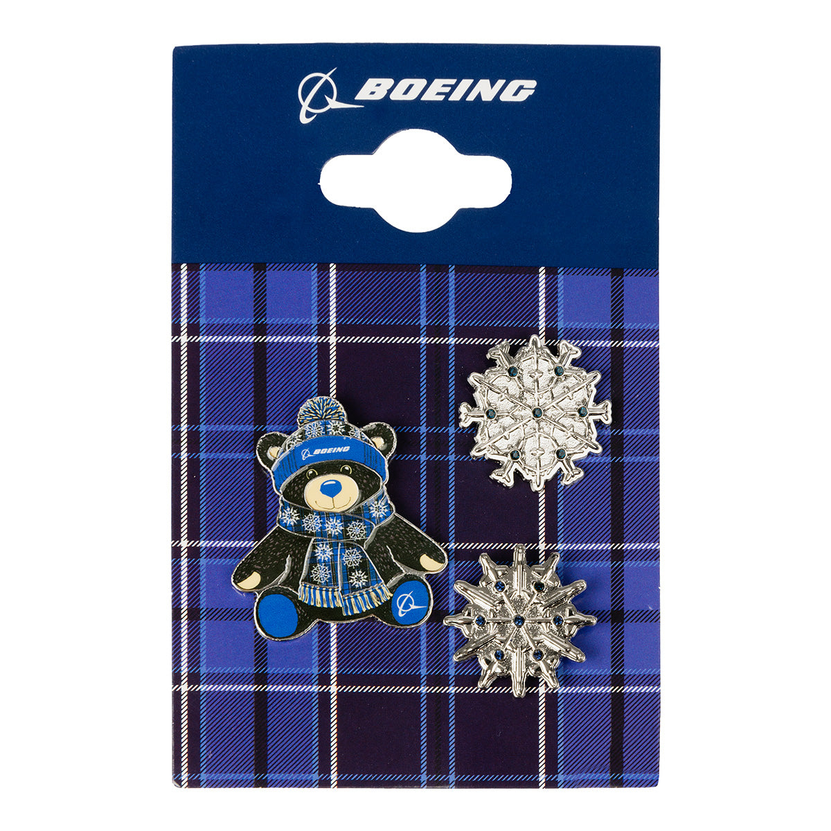 The Boeing 2026 Jet Snowflake Lapel Pin Set by BOEING includes three soft enamel pins—featuring a bear in winter attire with signature Boeing branding and two silver snowflake designs—arranged on a blue plaid card with the Boeing logo at the top, making them perfect holiday collectible pins for any fan.