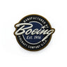 Round embroidery patch bearing Manufactured by Boeing Aircraft Company U.S.A. in white on blue, bordered in brown. Includes Est. 1916 and a star near the top, featuring the iconic Boeing script logo. Product: Red Canoe Boeing Script Logo Patch by The Boeing Store.
