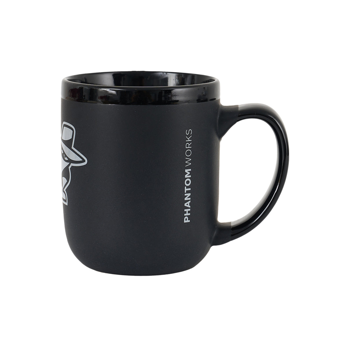 The Boeing Phantom Works 2025 Ceramic Mug by BOEING is a black ceramic mug with a large handle, featuring "PHANTOM WORKS" printed vertically in white and part of a white graphic—ideal for aerospace enthusiasts.