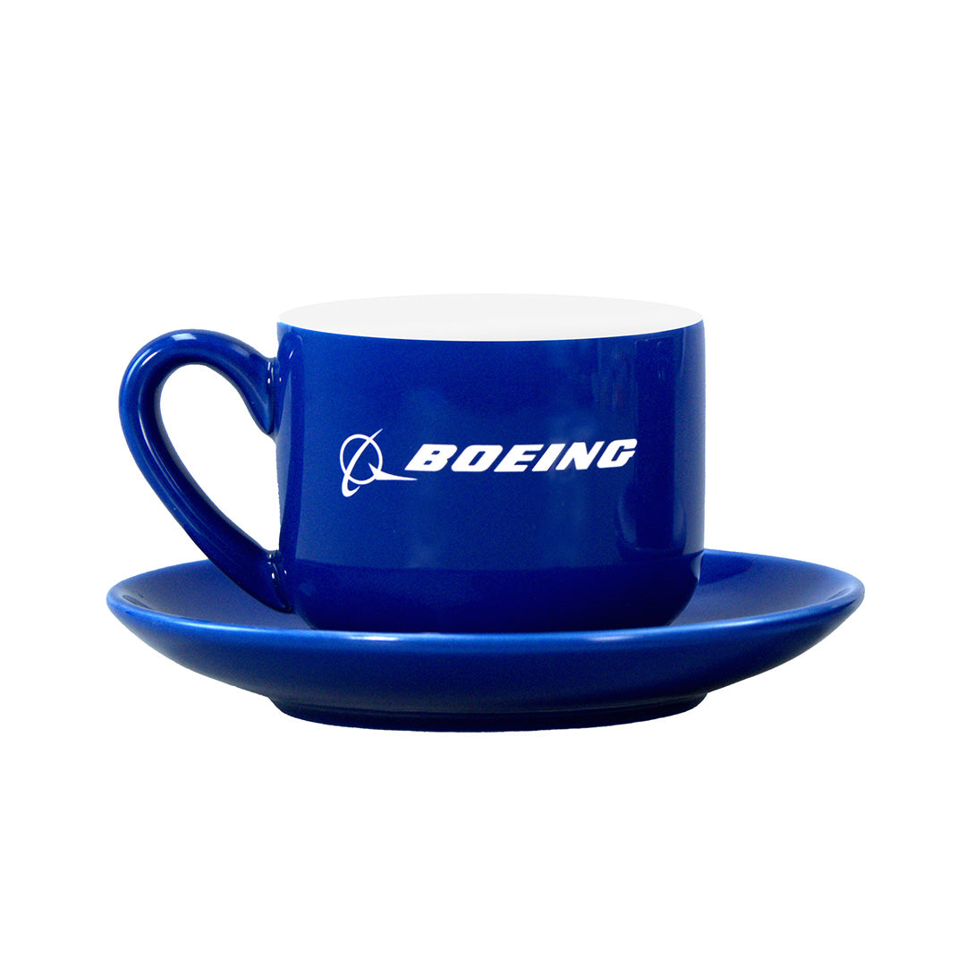 The Boeing Signature Espresso Cup & Saucer Set by BOEING showcases a blue ceramic coffee cup with a matching saucer and a white Boeing logo displayed on the cup, beautifully photographed against a white background—an ideal choice for those looking for stylish white stoneware or an elegant espresso cup set.