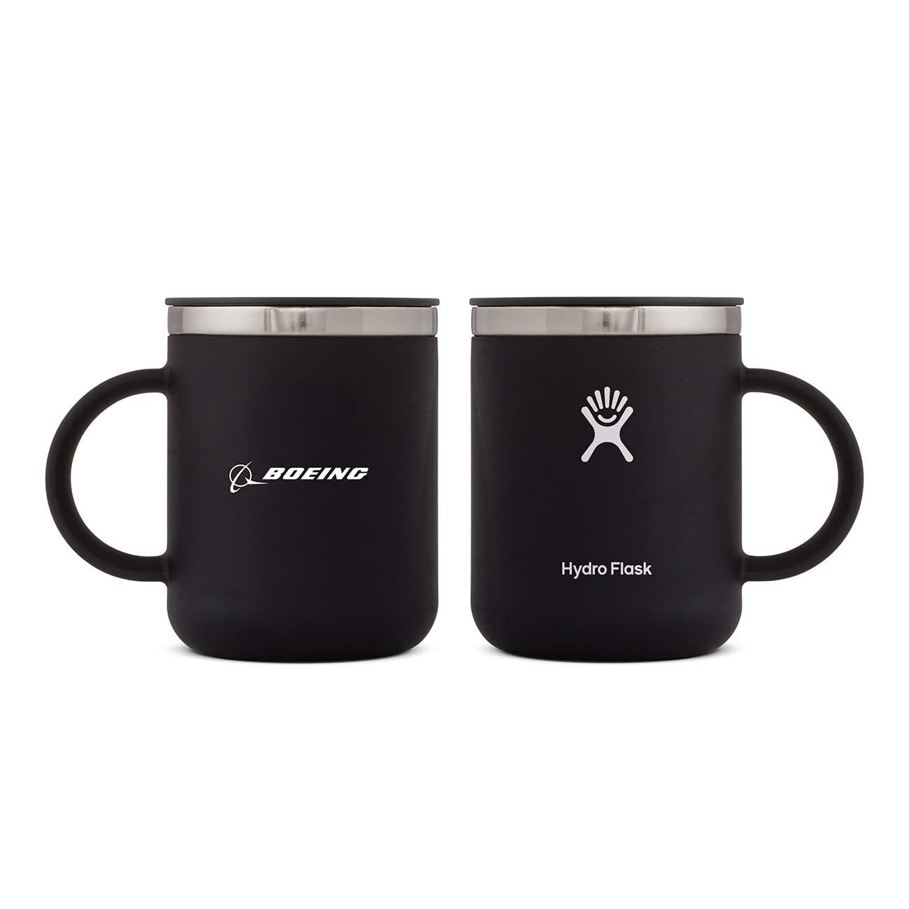 The Hydroflask Boeing Coffee Mug from The Boeing Store includes two black, stainless steel insulated mugs with handles and metallic rims. The left mug displays the Boeing logo, while the right features the Hydro Flask logo and boasts TempShield™ insulation technology.