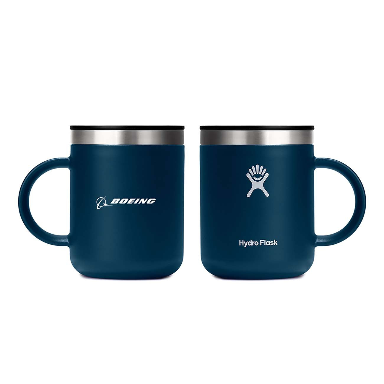 Two dark blue Hydroflask Boeing Coffee Mugs from The Boeing Store sit side by side showcasing TempShield™ insulation. One mug has the Boeing logo, the other displays the Hydro Flask logo, while both insulated mugs have silver rims and black lids for superior temperature retention.