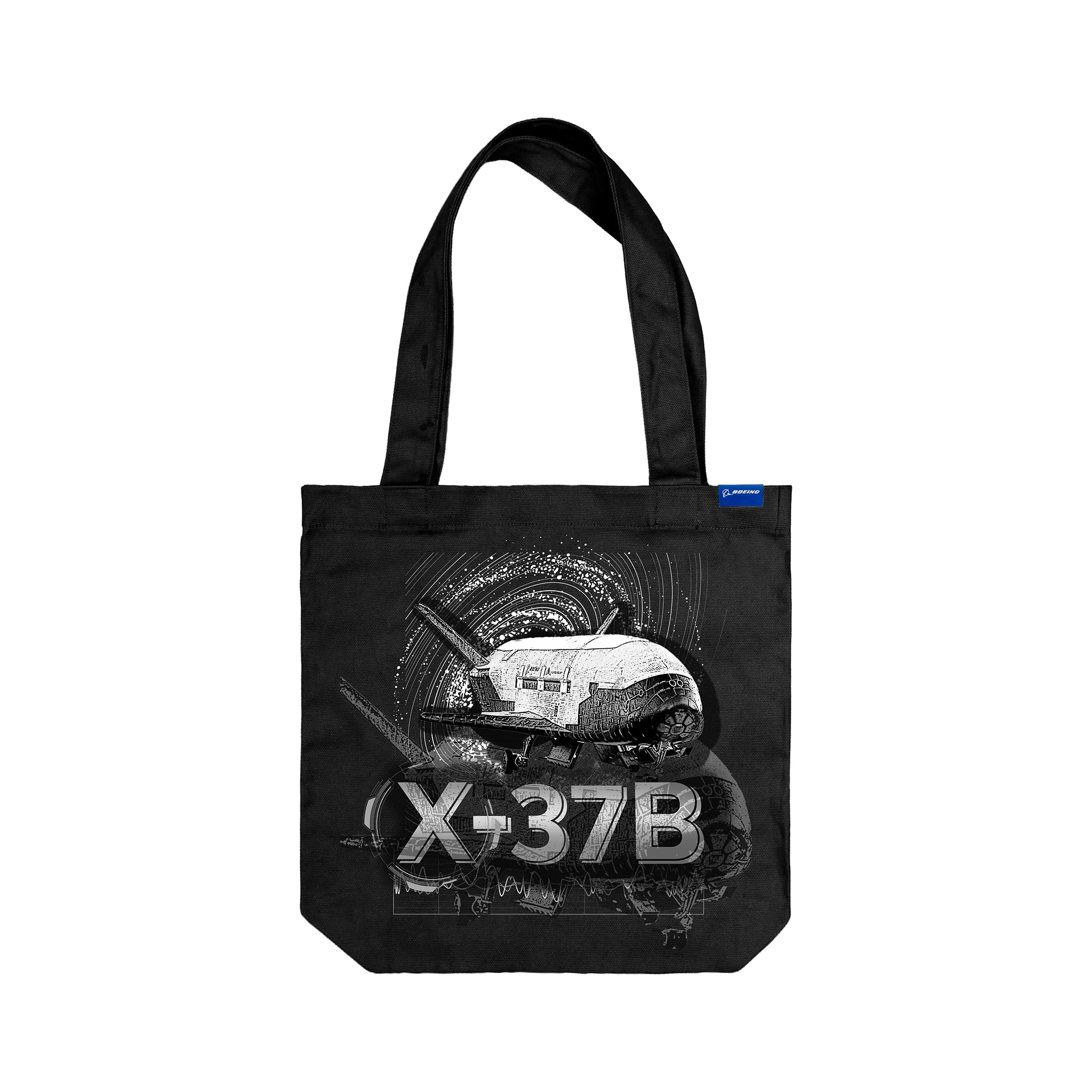 The Boeing X-37B Orbital Test Vehicle Graphic Tote by BOEING features a white spaceplane illustration above bold "X-37B" text on a starry black background with a blue tag—ideal for fans of Boeing and spaceflight.