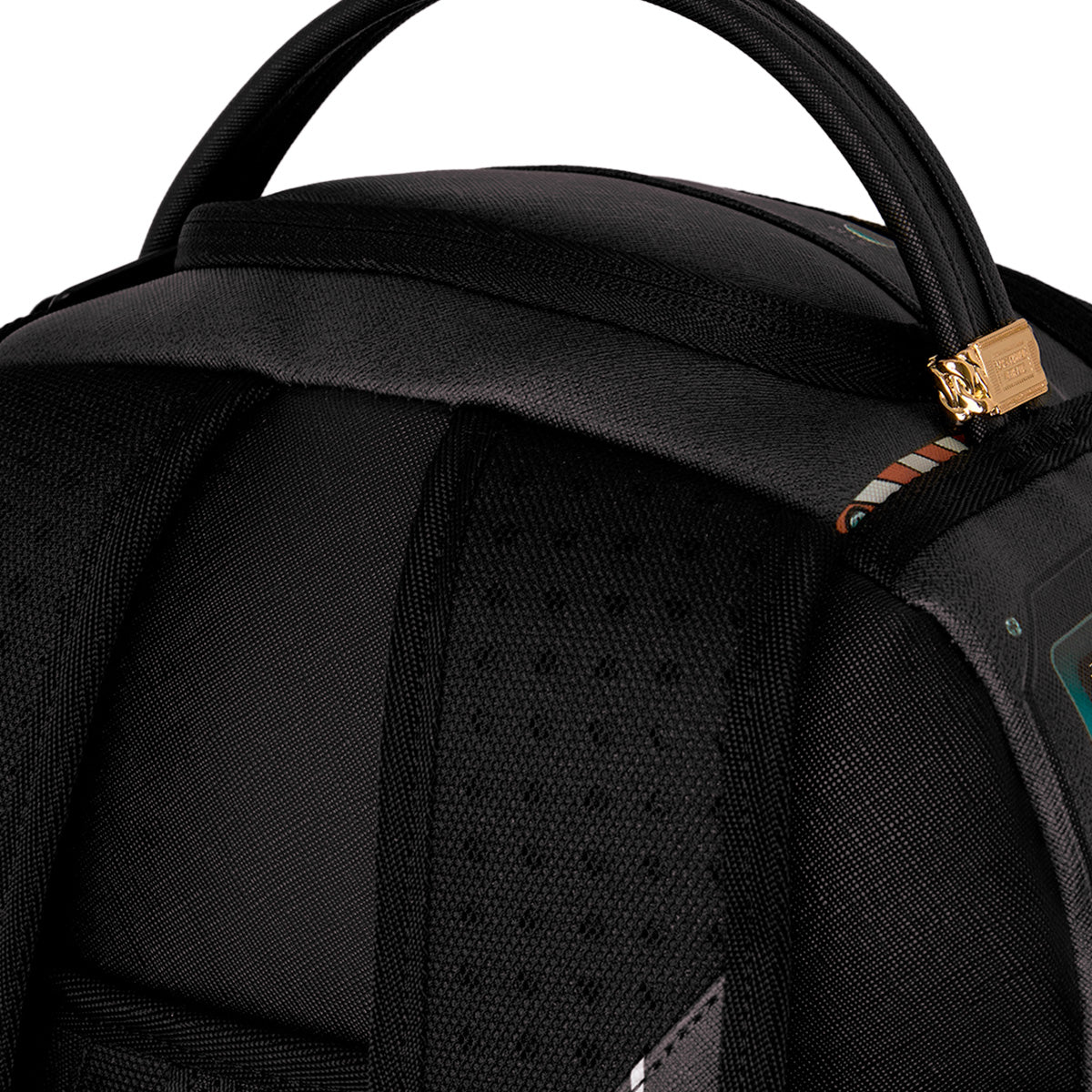 Close-up of the top section of the Sprayground Boeing F/A-18 Super Hornet DLXSR Backpack by BOEING, featuring padded shoulder straps, a sturdy handle, a gold zipper, and an easily accessible laptop compartment—making it ideal for use as carry-on luggage.