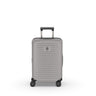 The Victorinox Airox Advanced Frequent Flyer Carry-on in Stone features a sleek silver hard-shell design with textured surface, four black swivel wheels, and a telescopic handle. The VICTORINOX logo is proudly displayed on the front, echoing Swiss craftsmanship.