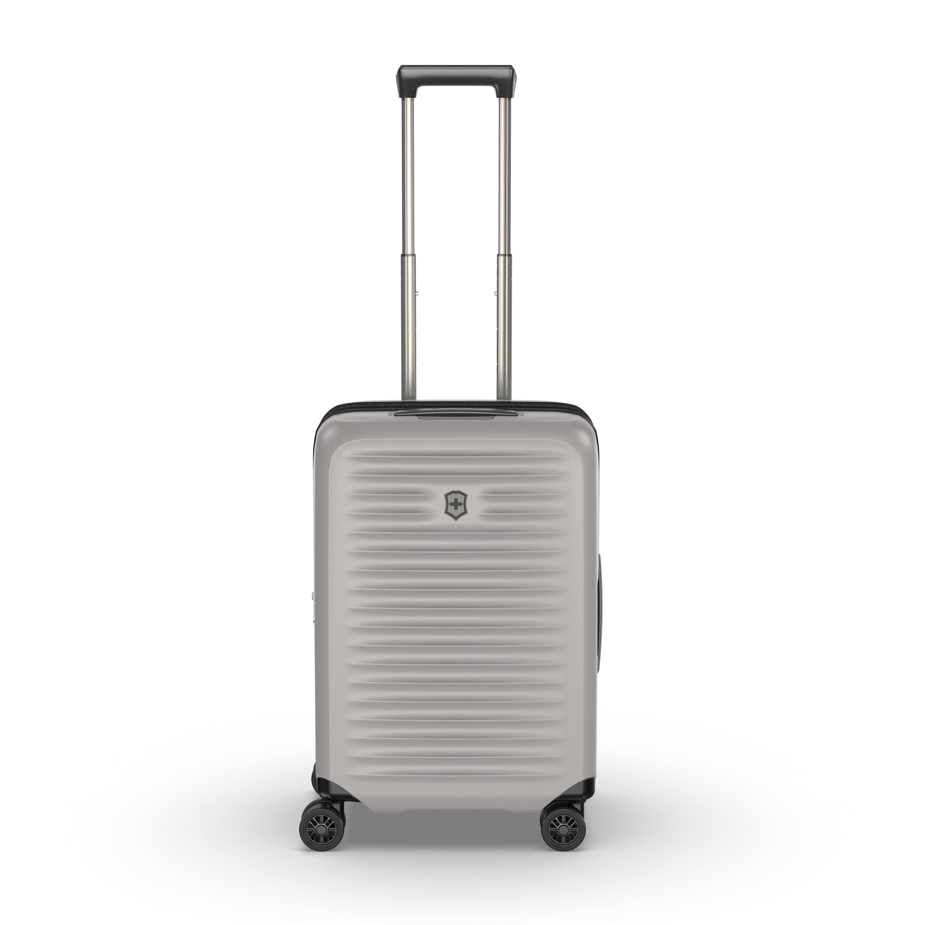 The Victorinox Airox Advanced Frequent Flyer Carry-on Plus in Stone, by VICTORINOX, features a silver ribbed design with a lightweight hard shell. It includes four wheels and an extended telescopic handle, enhanced by dual caster wheels and adorned with a small emblem on the plain white front.