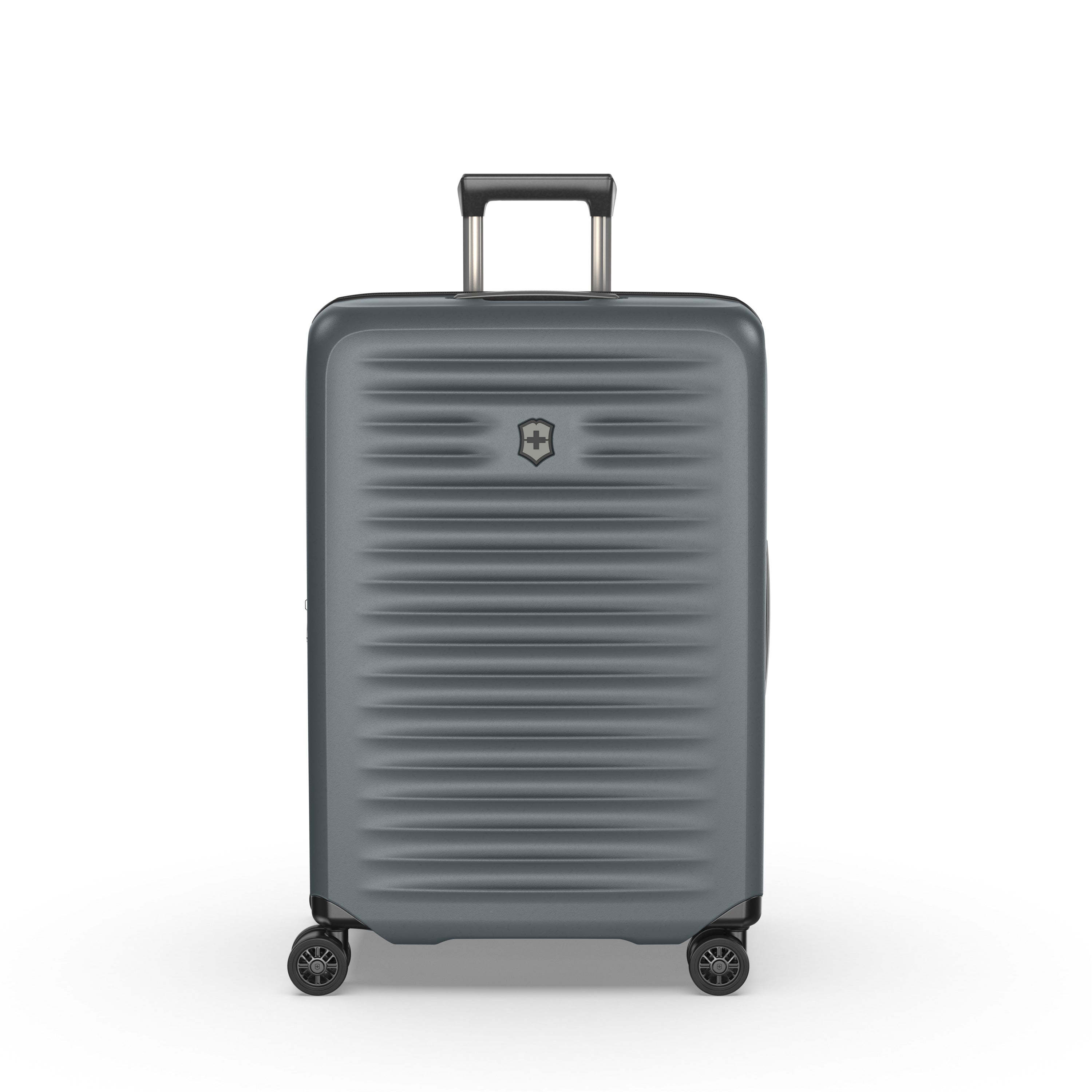 The Victorinox Airox Advanced Medium - Storm by VICTORINOX is a large, gray suitcase with a hard-shell exterior and silver emblem. It features intelligent organization, four black wheels, an adjustable black handle, and horizontal grooves for added texture to its lightweight design.