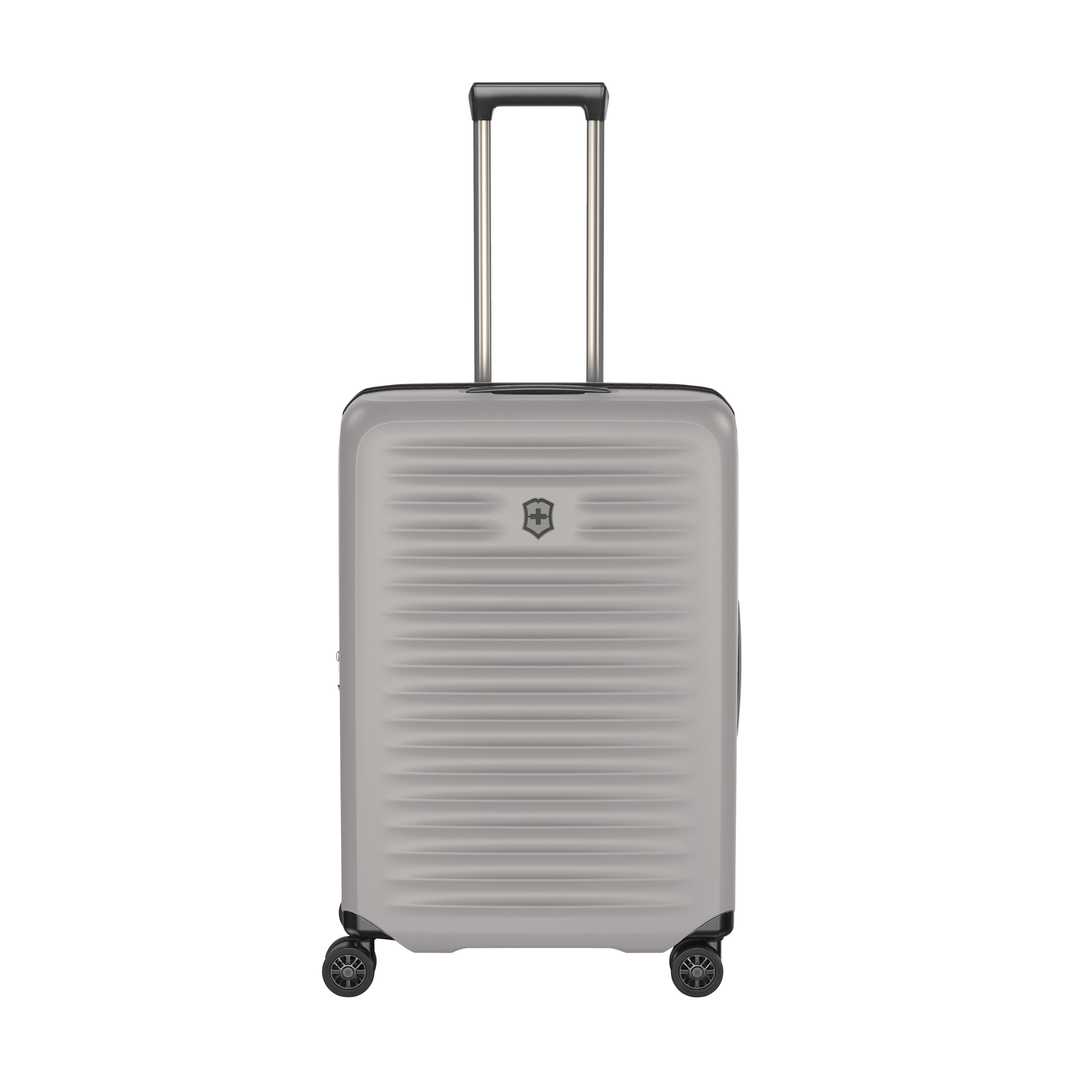 The Victorinox Airox Advanced Medium - Stone is a lightweight hard-shell suitcase with four wheels and a telescopic handle, featuring a ribbed texture, front logo, and anti-microbial interior.