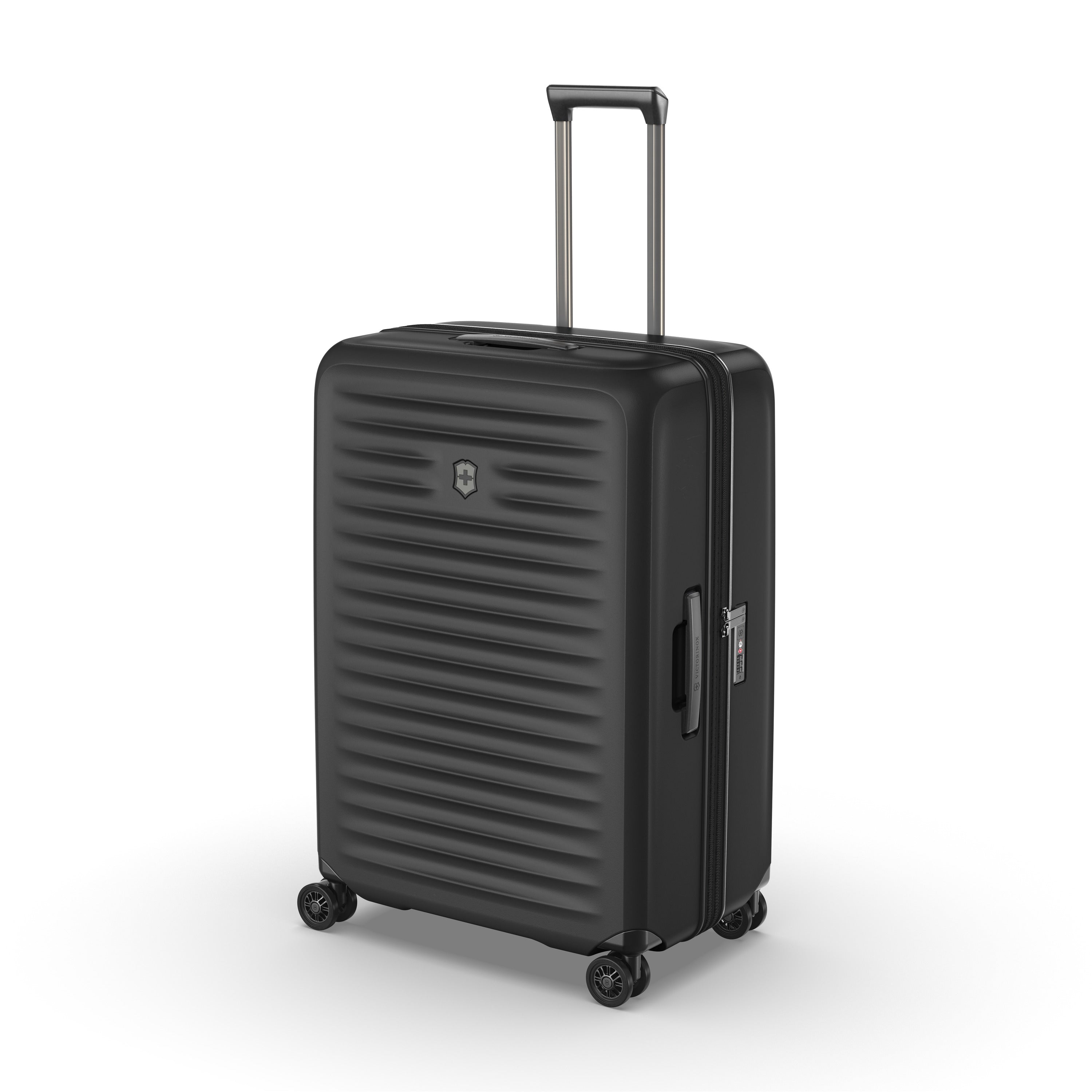 Meet the Victorinox Airox Advanced Large - Black: a stylish suitcase with a Swiss-engineered hard shell and sleek horizontal grooves. It features a telescopic handle, four wheels for smooth maneuvering, silver zippers, and a distinguished silver emblem on the front—your perfect travel companion.