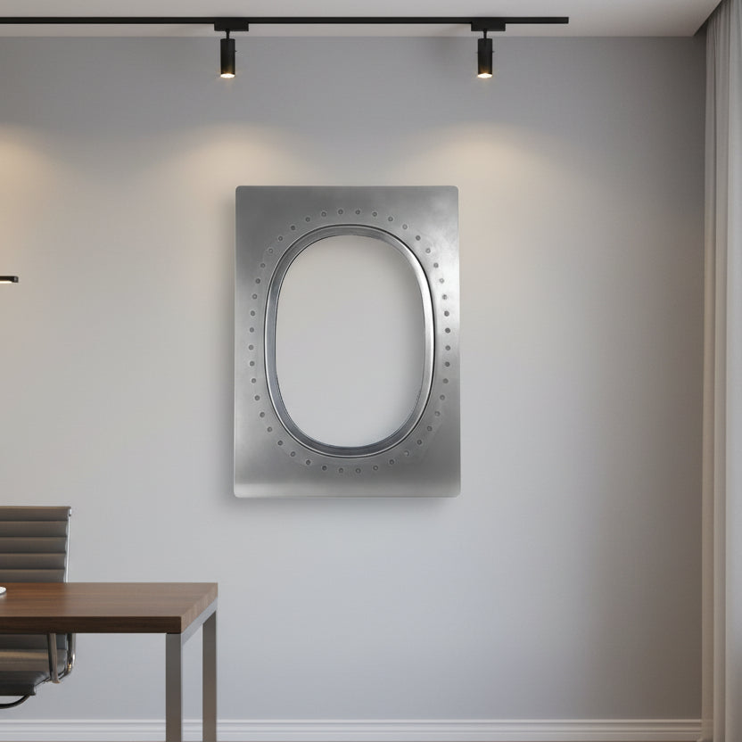 The Boeing 777 Natural Finish Window by Boeing is a rectangular mirror with a metallic frame, oval inner border, and dotted detailing inspired by a 777 window, shown against a plain white background.