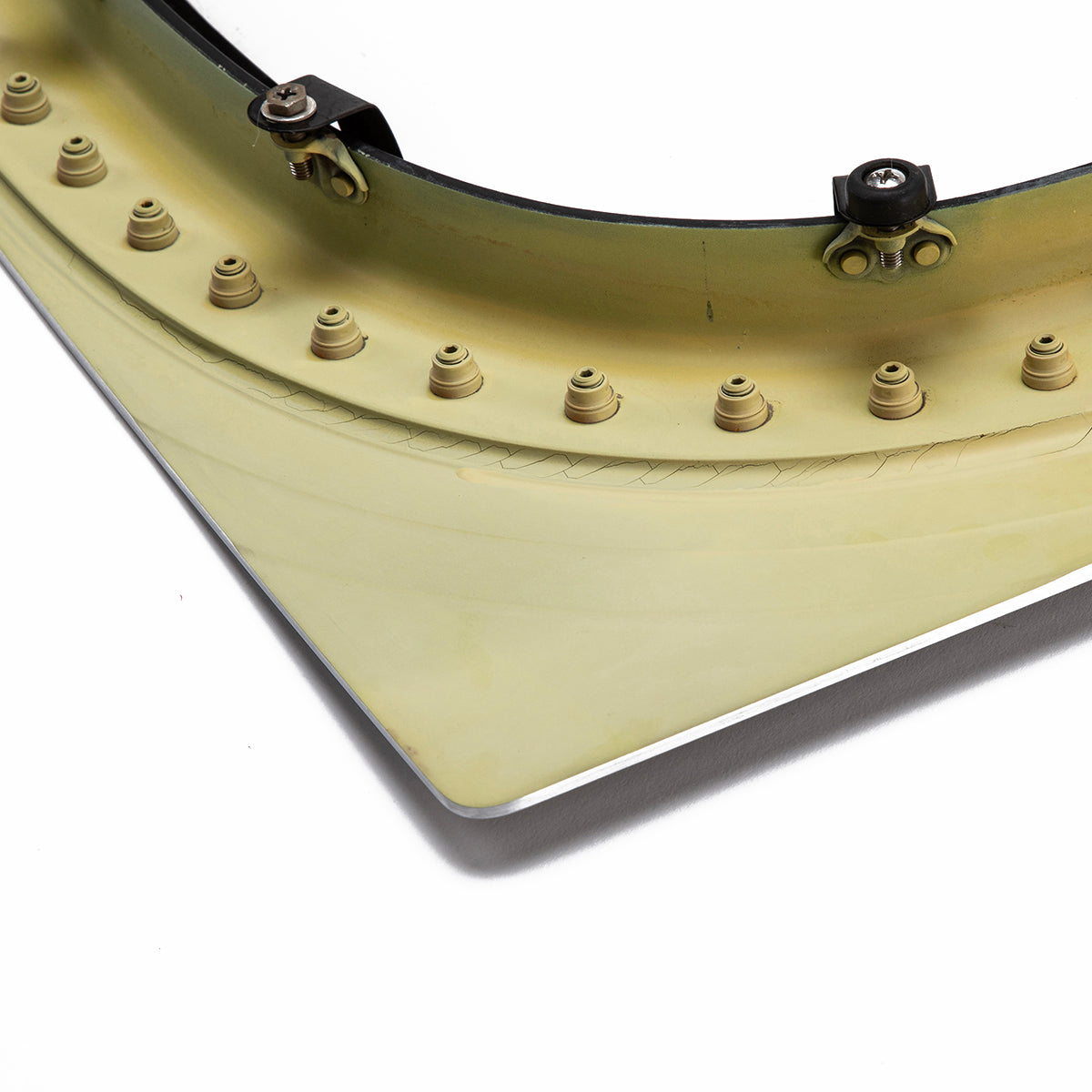 A close-up shows the Boeing 777 Natural Finish Window by Boeing, featuring a curved yellowish frame with evenly spaced small bolts and three black metal clips at the top against a white background.