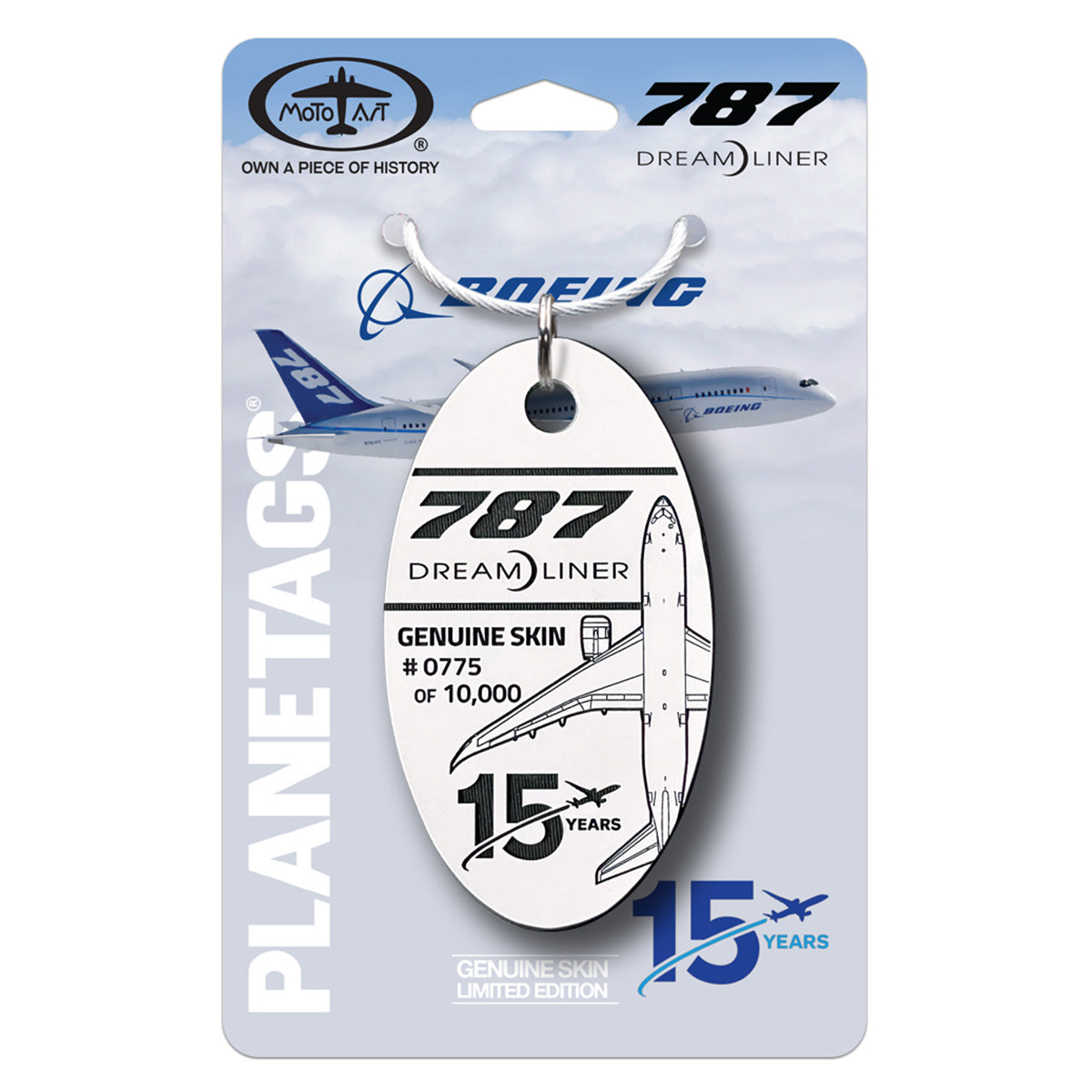 The PlaneTags Boeing 787 Series by BOEING features an oval keychain labeled “787 Dreamliner” and “Genuine Skin 15 Years,” crafted from original carbon-fiber composite. Each tag is attached to a card displaying a Boeing 787 aircraft, with blue logos and the PLANE TAGS branding. This limited edition is individually numbered, with this piece being number 0775 out of 10,000.