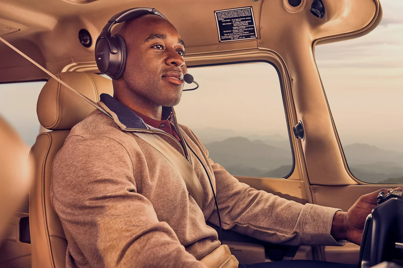 Product Feature section with male pilot wearing Bose A30 Headset while flying a small plane.