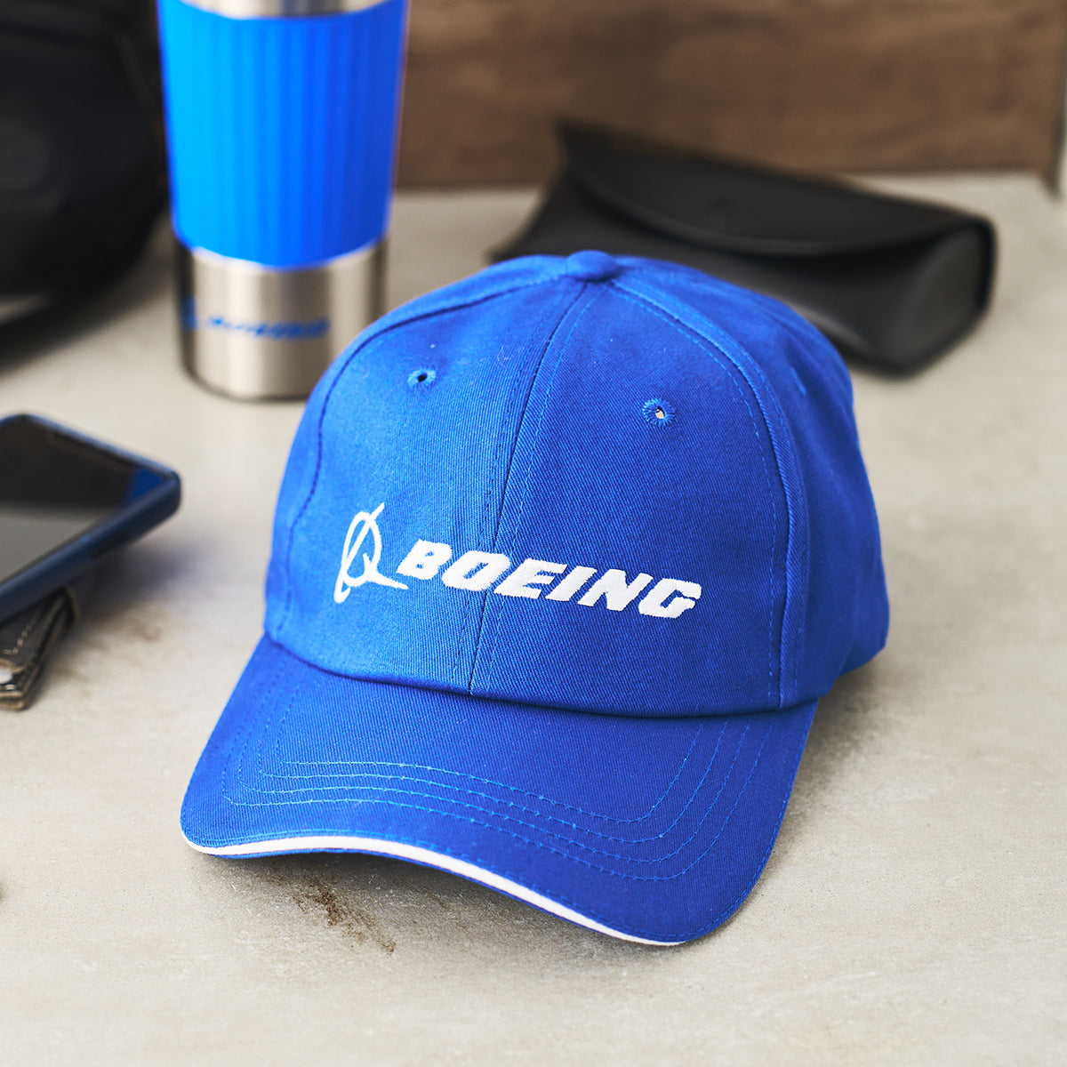 A blue baseball cap featuring the Boeing logo prominently displayed on the front.