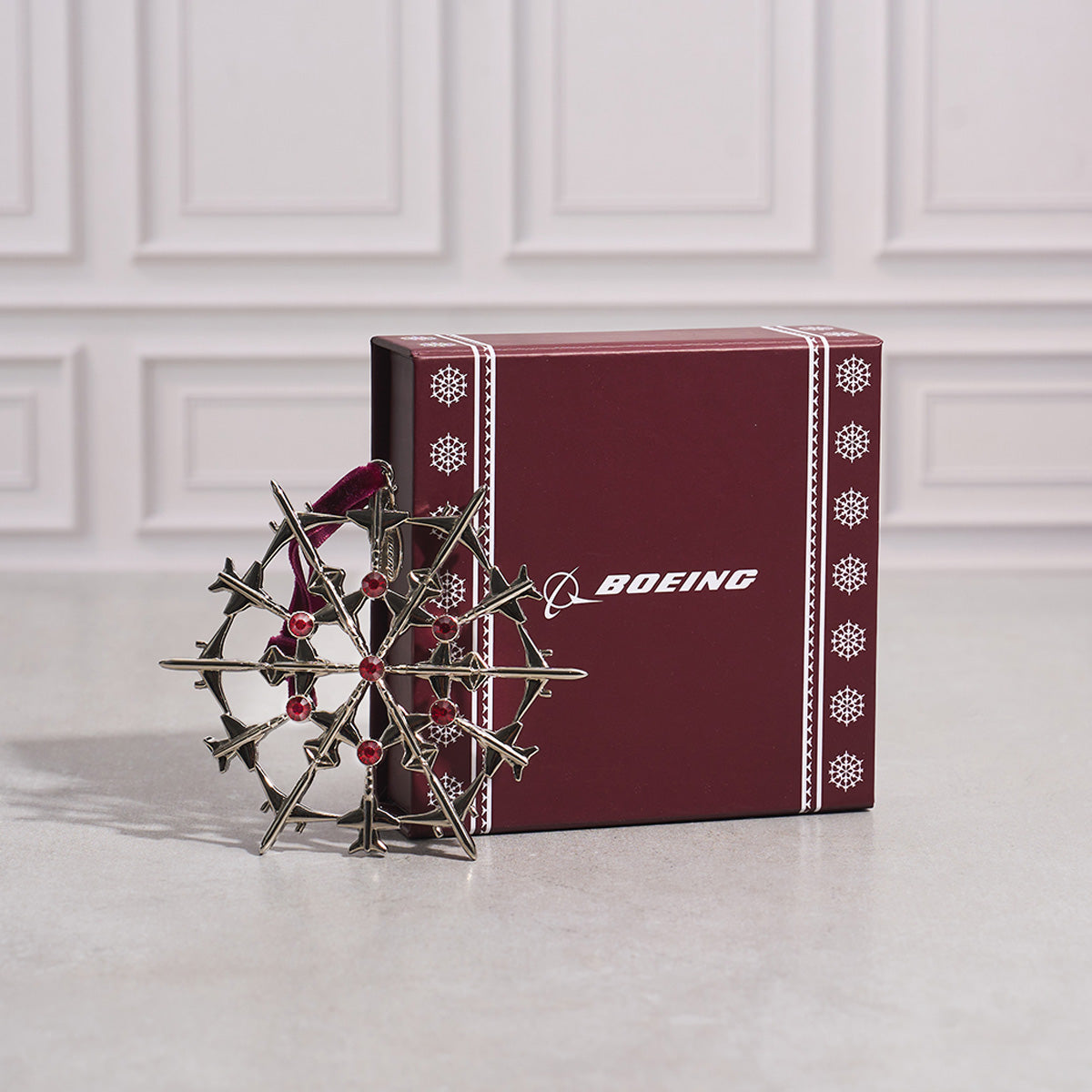 Decorative Jet Snowflake ornament with red crystals and a Boeing branded box.