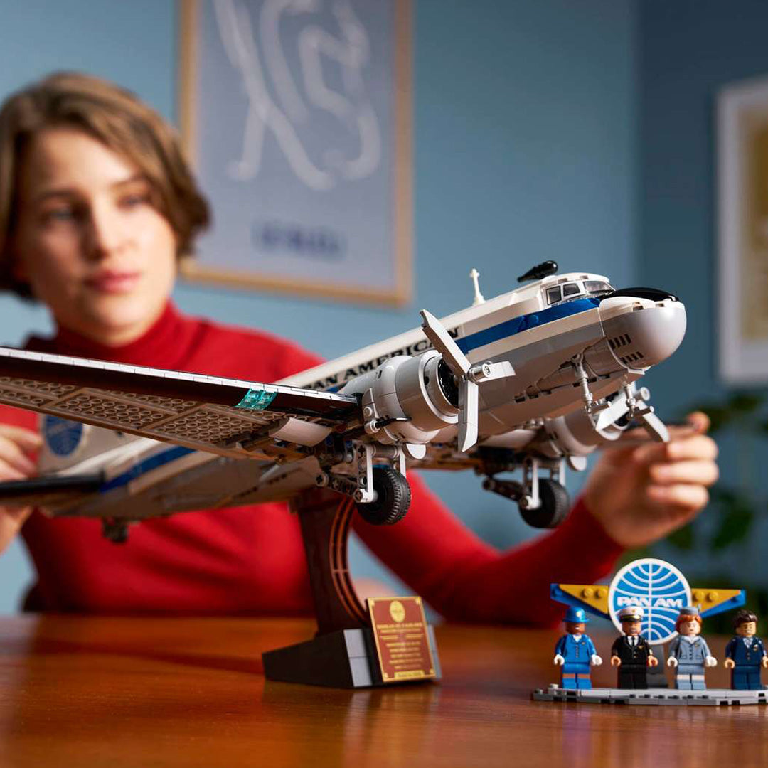 Vintage lifestyle of child building and playing with a LEGO set of the Boeing Pan Am 747 model.