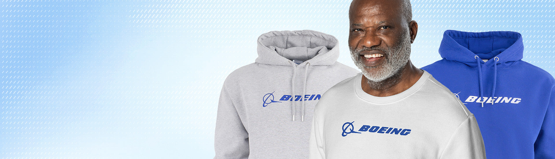 Grey and blue Boeing Signature hoodies and man wearing white Signature crewneck on a pale blue background.