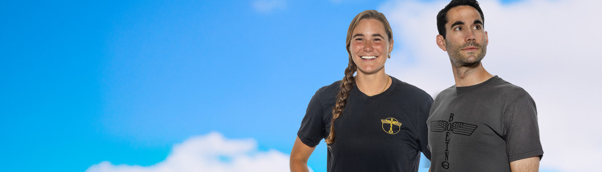 Desktop banner featuring a man and woman wearing Boeing Heritage t-shirts, posed against a blue sky background.