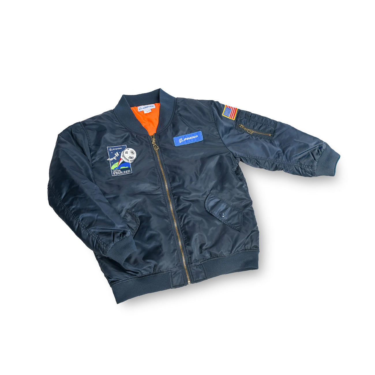 The Boeing Stores Boeing Kids Space Jacket is a dark bomber with space-themed patches, including an American flag on the right sleeve, and a Boeing logo. Its water-resistant with a bright orange lining and front zipper for added flair.