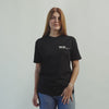 Lifestyle video of woman wearing a MQ-28 T-shirt against a light grey background.