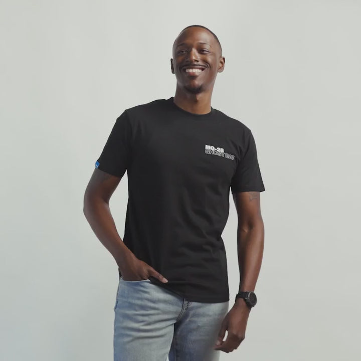 Lifestyle video of man wearing MQ-28 Ghost Bat T-Shirt against a light grey background.