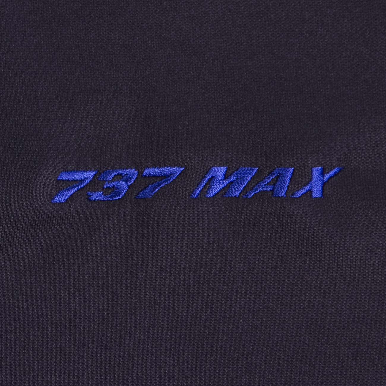 Close-up of the Boeing 737 MAX Polo by The Boeing Store featuring blue embroidery on a dark, moisture-wicking fabric with UV protection.