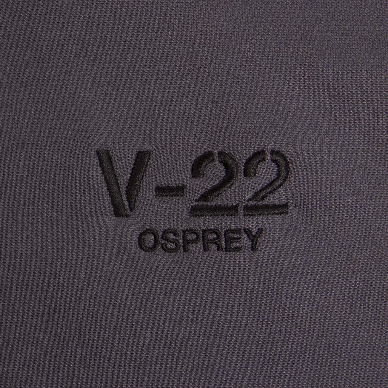 The Boeing Stores V-22 Polo is a black, moisture-wicking shirt with UV protection, featuring embroidered V-22 OSPREY text on a dark gray background.