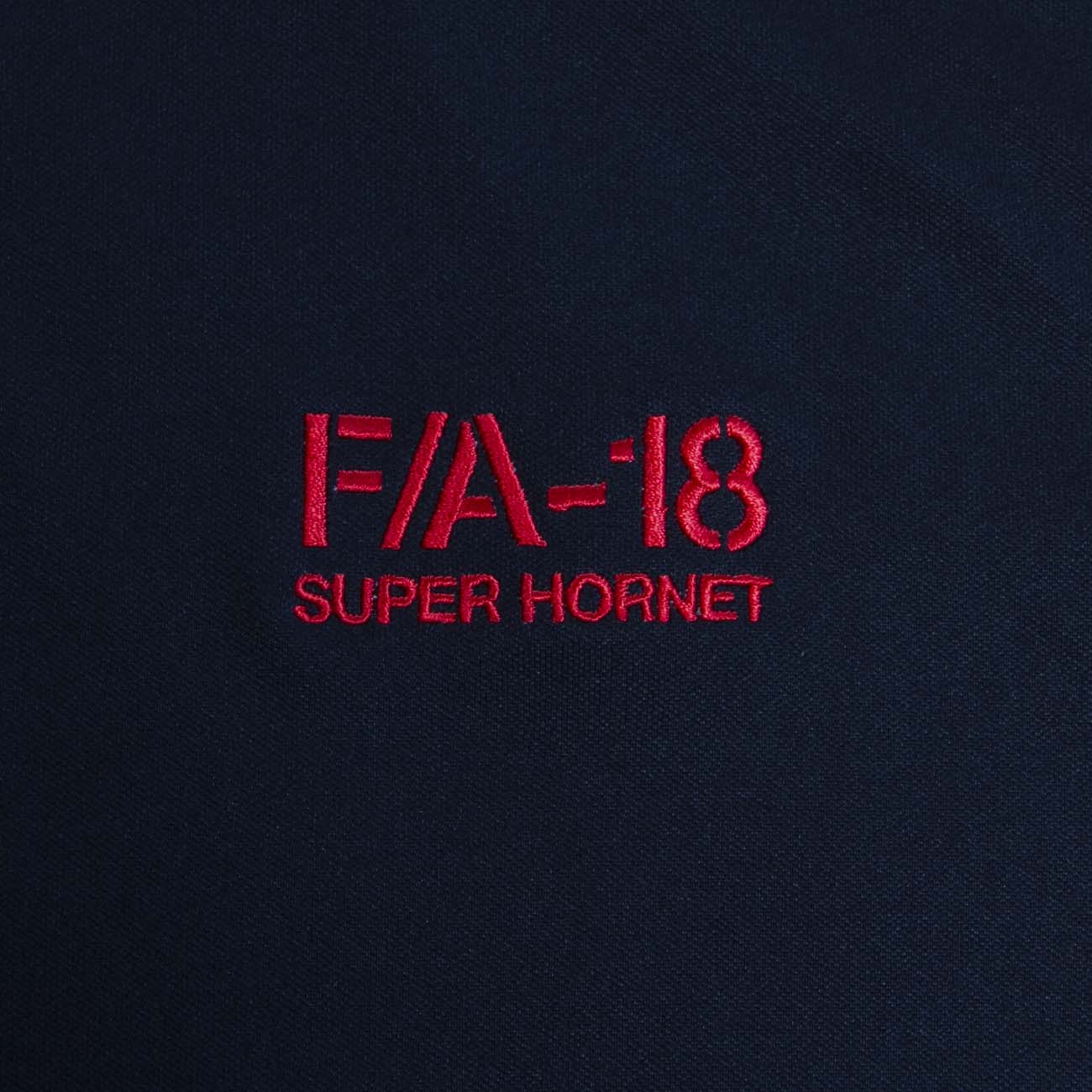 The Boeing Stores Boeing F/A-18 Polo features red embroidered text on a dark fabric reading F/A-18 SUPER HORNET, showcased on a moisture-wicking shirt.