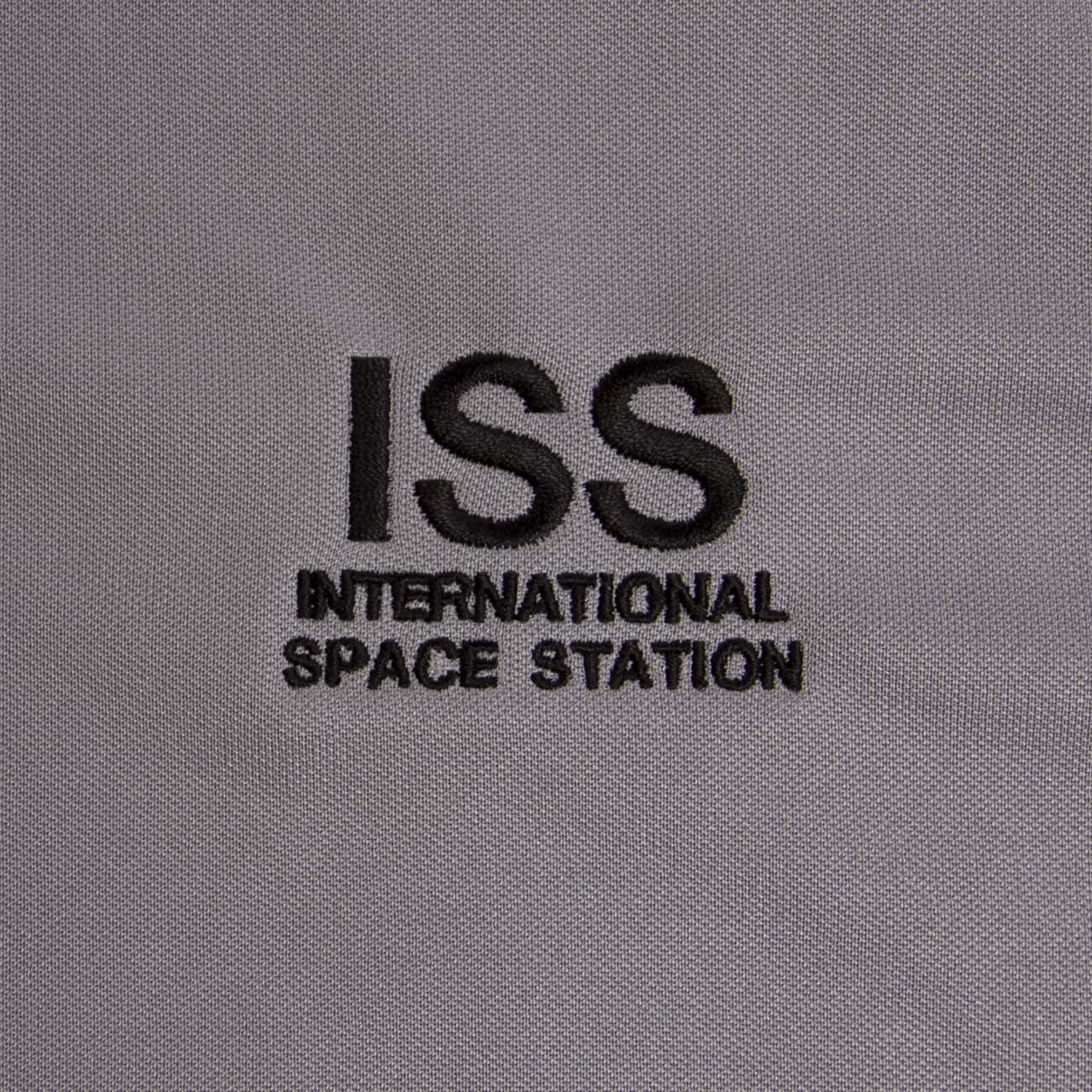 The Boeing Stores Boeing ISS Polo features grey fabric embroidered with ISS International Space Station in black letters and offers UV protection for outdoor safety.