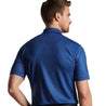Model wearing the polo shirt showing the back side of the polo. 