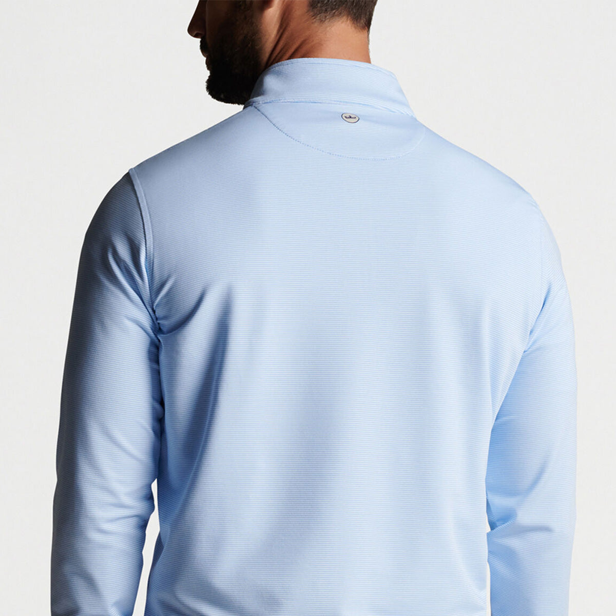 Backside of the cottage blue quarter-zip on a male model.