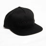 The Boeing Store Richardson Boeing Signature Logo Flat Bill Hat is a black baseball cap featuring an embroidered black Boeing logo on the front, with six panels and a sleek snapback closure for a perfect fit.