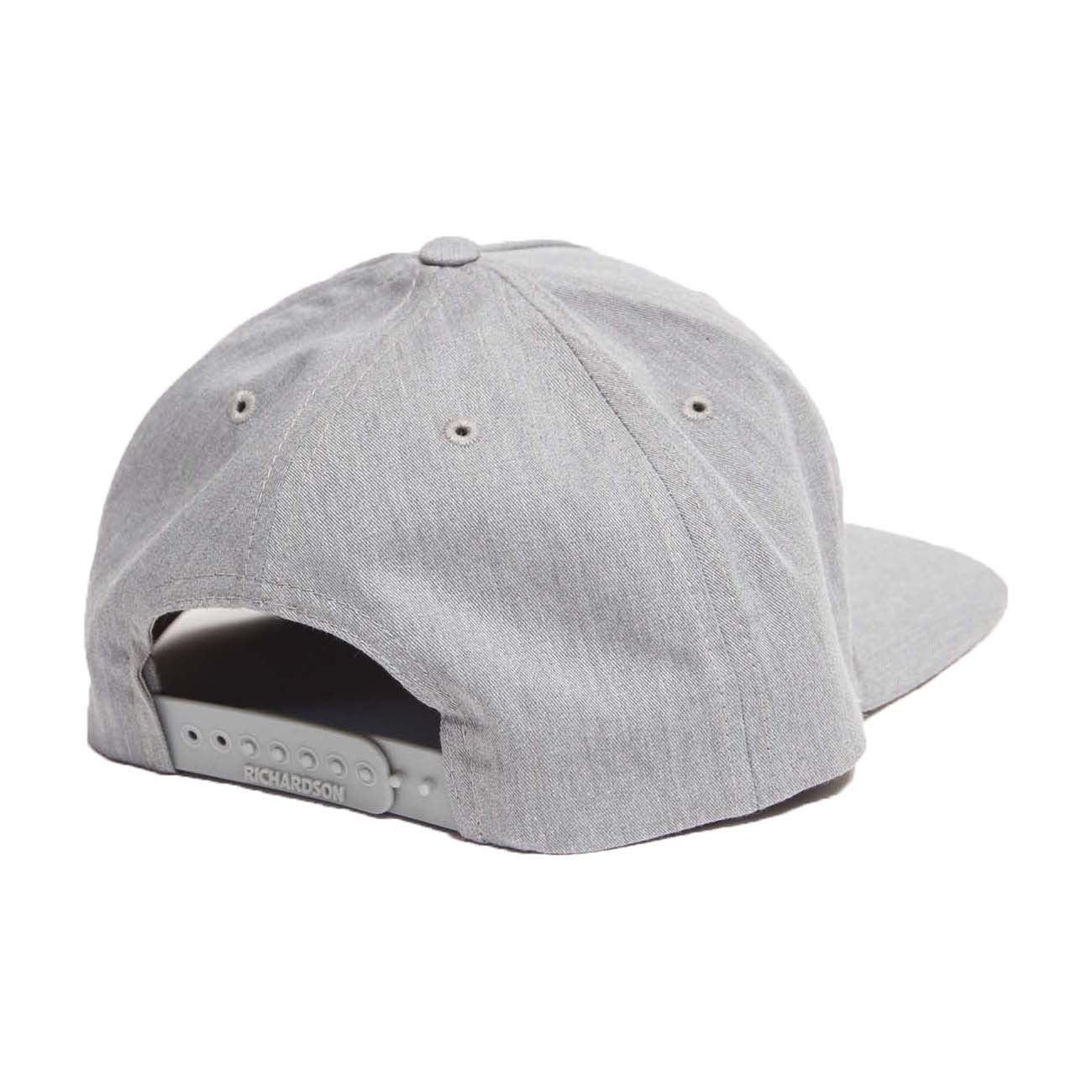 The Boeing Stores Richardson Boeing Signature Logo Flat Bill Hat in gray features an adjustable strap, embroidered ventilation eyelets, and a slightly curved textured brim, complete with the signature logo.