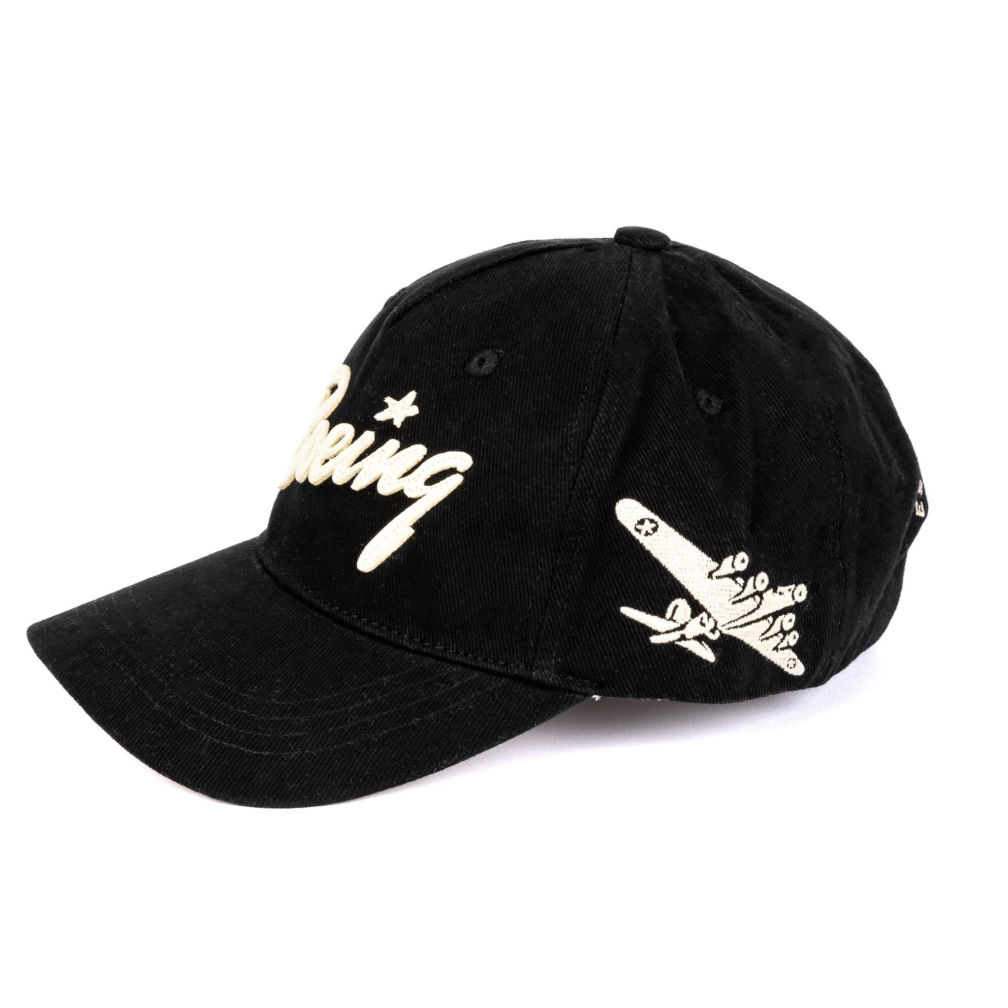 The Boeing Stores Red Canoe Boeing B-17 Script Hat is a black cotton twill cap featuring Boeing embroidered in white on the front, with a white airplane graphic and small clouds on the side.