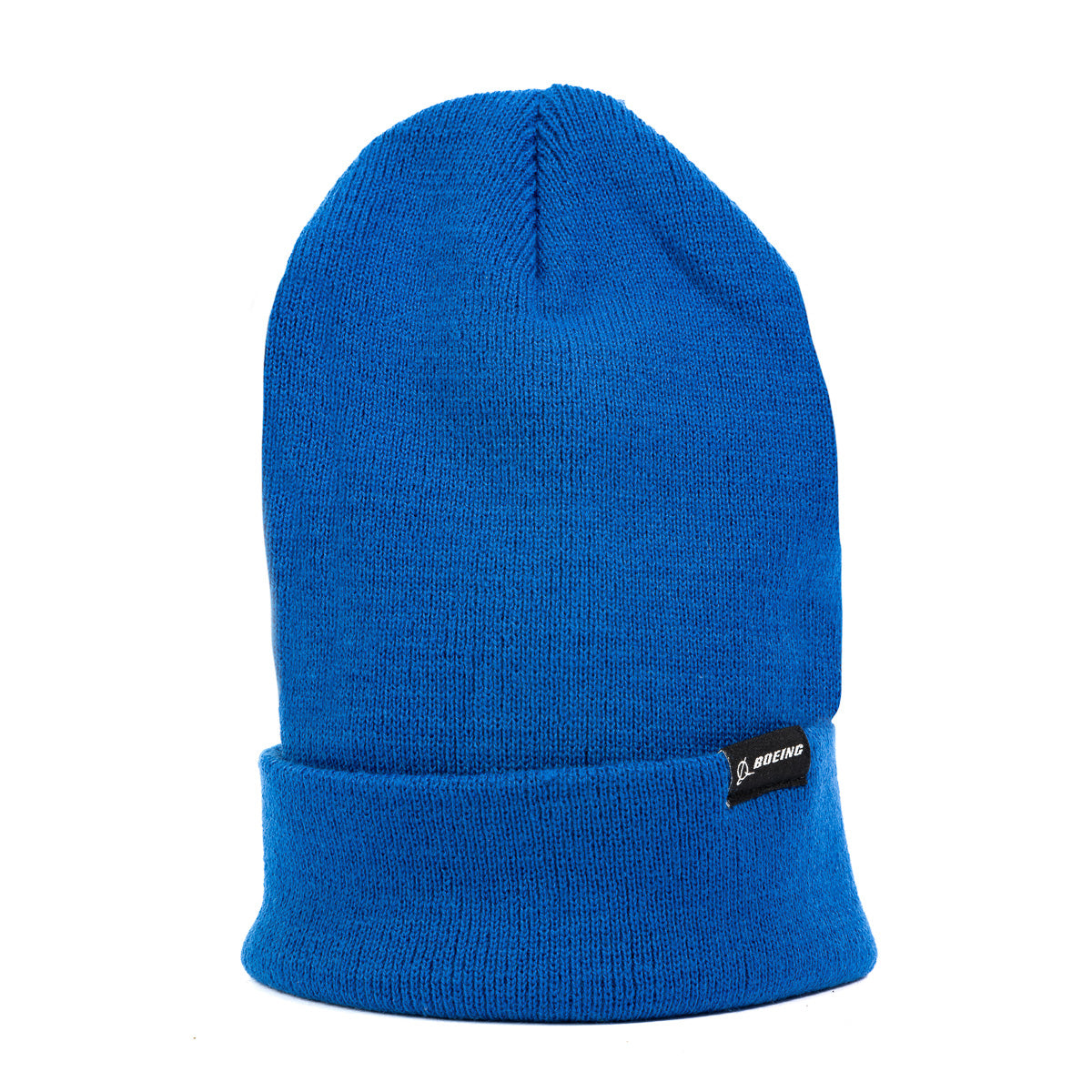 The Boeing Store's Boeing Signature Logo Beanie is a bright blue knit hat with a folded brim and a small black tag featuring the beanie logo on the front, shown against a plain white background.
