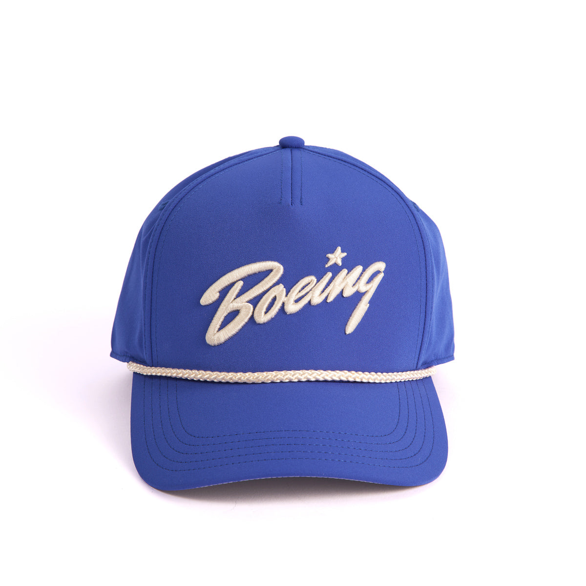 The Boeing Stores Boeing 5 Panel Nylon Hat is a stylish blue cap featuring the Boeing script logo in white cursive, a bold white nylon cord above the visor, and an adjustable snapback closure for a perfect fit against any plain white backdrop.