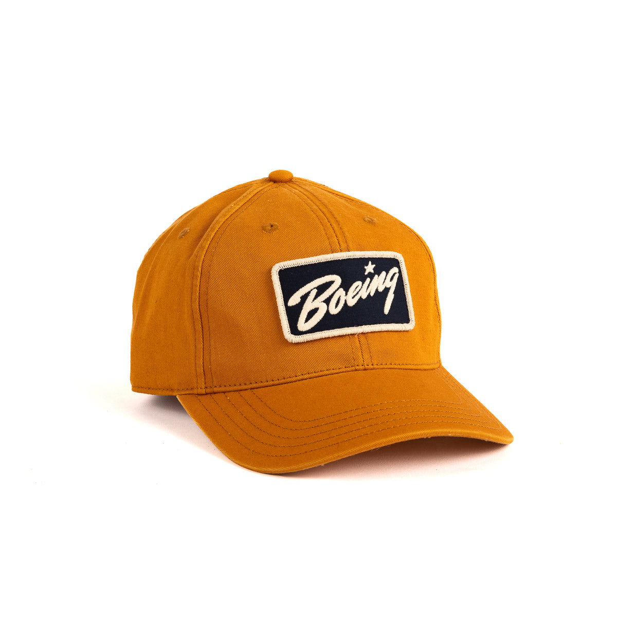 The Boeing Washed Twill Patch Hat from The Boeing Store is an orange cap featuring a black and white patch with the iconic Boeing script logo, complete with an adjustable buckle closure for a perfect fit.