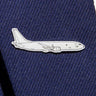 The Boeing Illustrated P-8 Lapel Pin from The Boeing Store is a silver-tone pin shaped like a jet, attached to dark blue textured fabric, subtly echoing the sleek design of the Boeing logo.