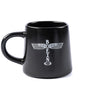 The Boeing Stores black ceramic mug features a white, vertical Boeing Airplane Company Logo with stylized wing graphics. Its microwave and dishwasher safe, boasting a thick handle for convenience.