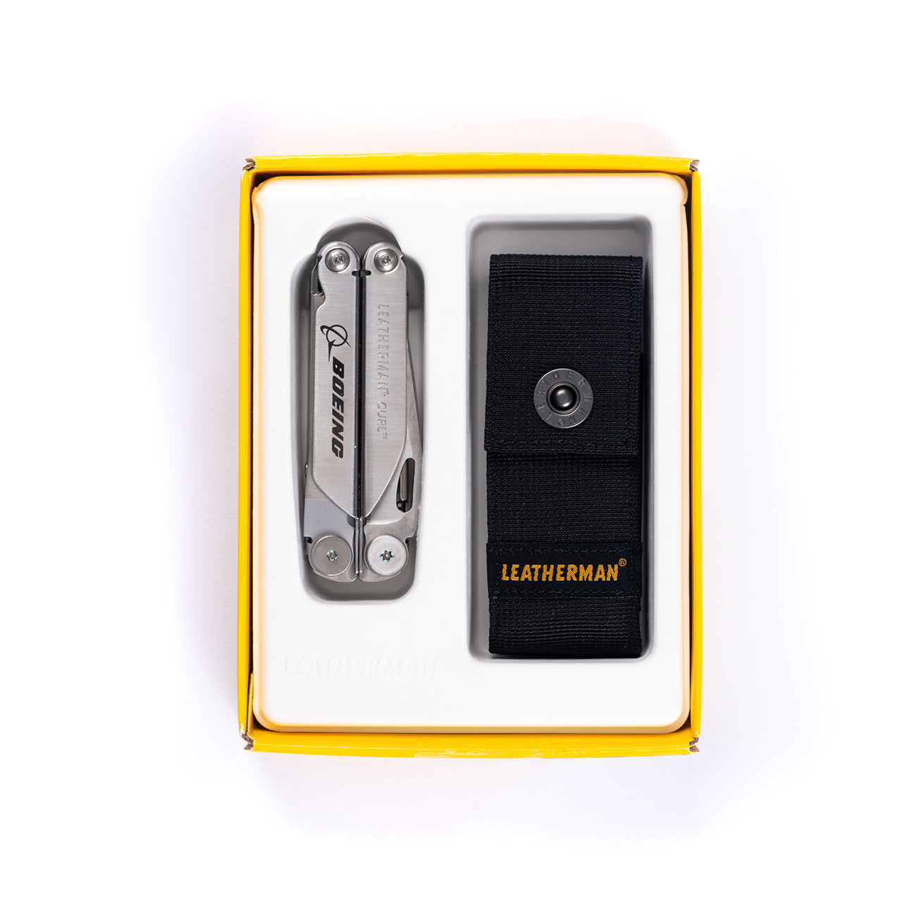 The Boeing Stores Leatherman Curl multitool, featuring a convenient pocket clip, comes elegantly packaged in a yellow-bordered box with a black sheath and displays the Boeing logo on its metal surface.
