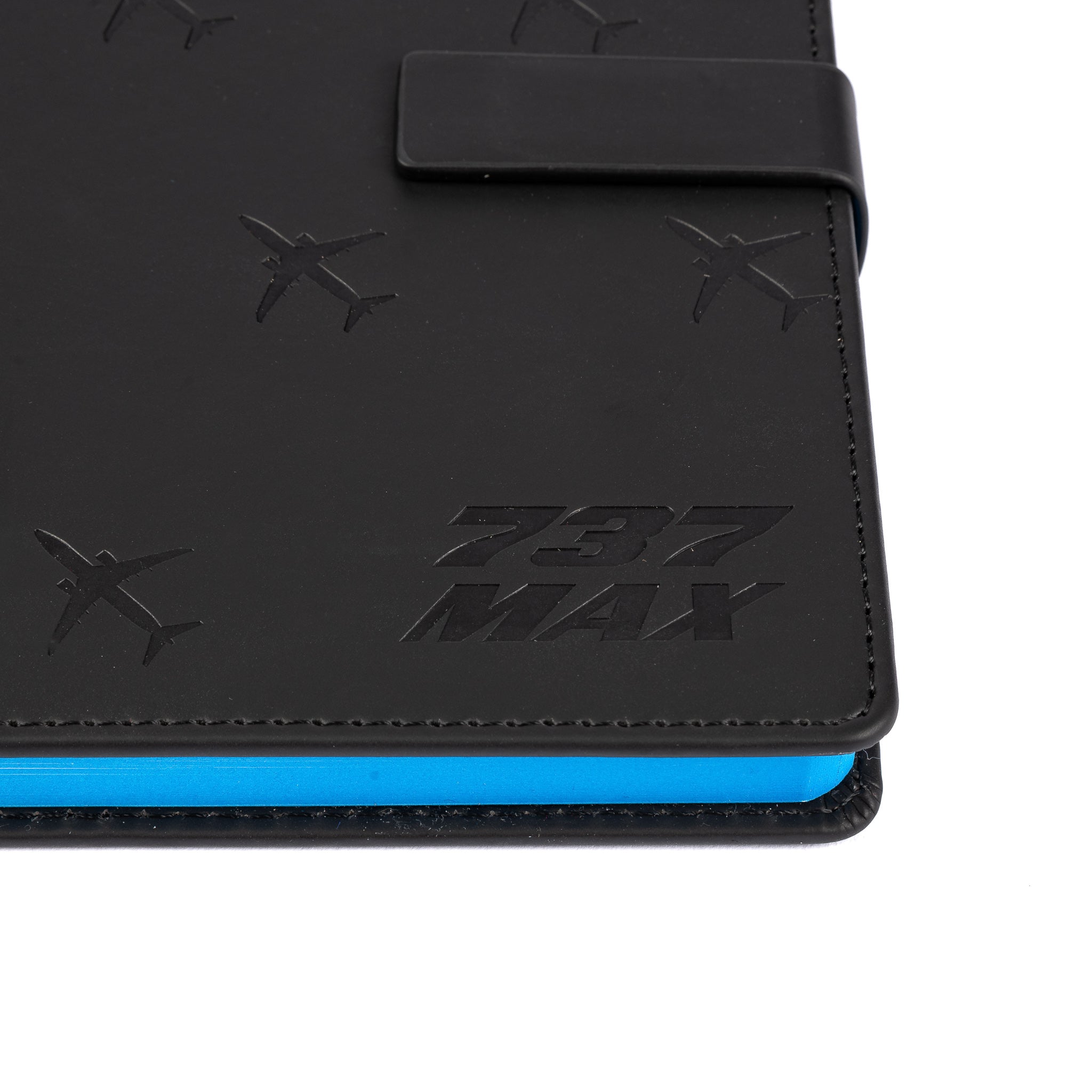 The Boeing Store’s Boeing 737 MAX Notebook features a black PU hardcover, blue-edged pages, and embossed airplane silhouettes with “737 MAX” on the cover—ideal for Boeing fans.