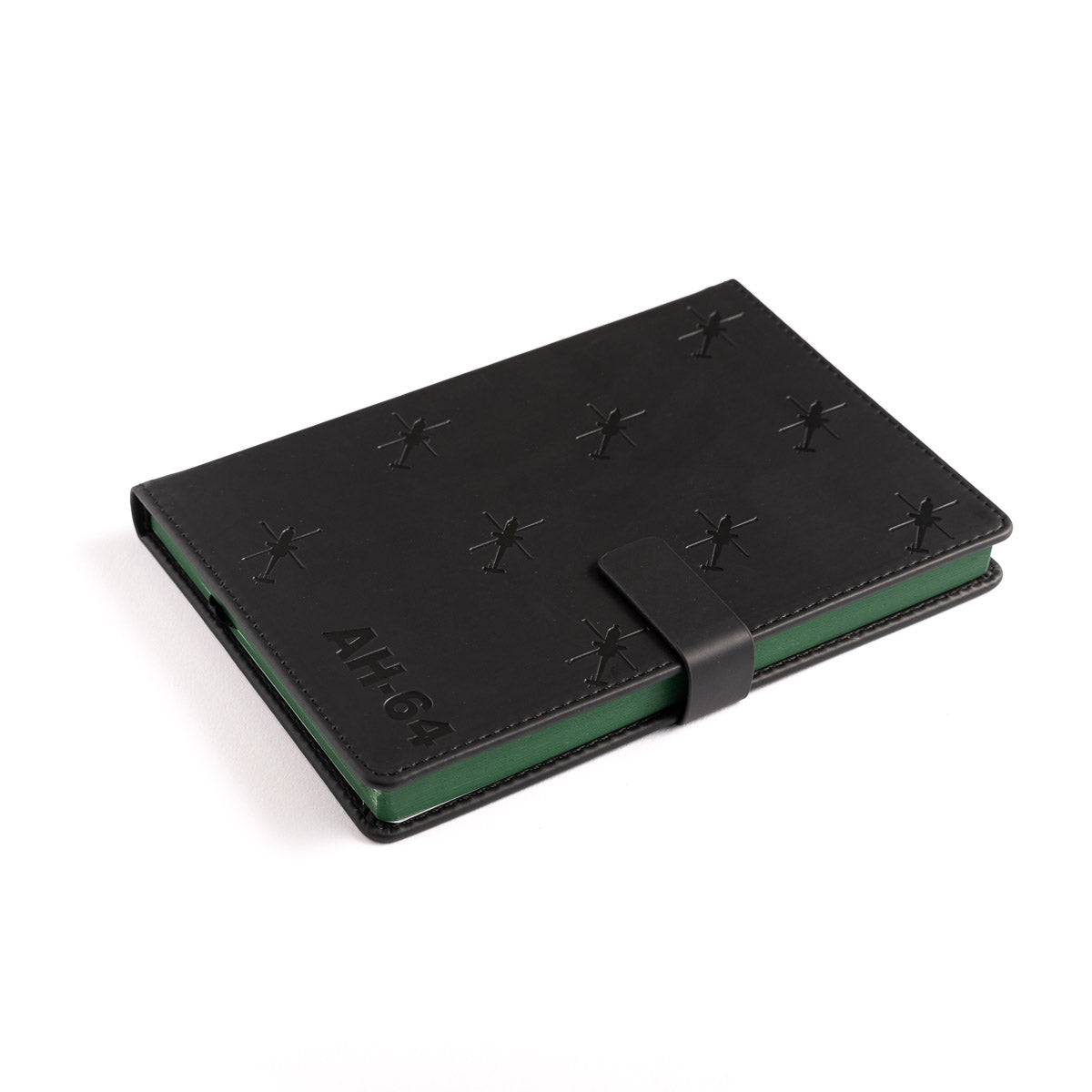 The Boeing Store’s Boeing AH-64 Apache Notebook is a closed black leather notebook with embossed star symbols, AH-64 on the cover, a black strap closure, and a green edge visible along the side.
