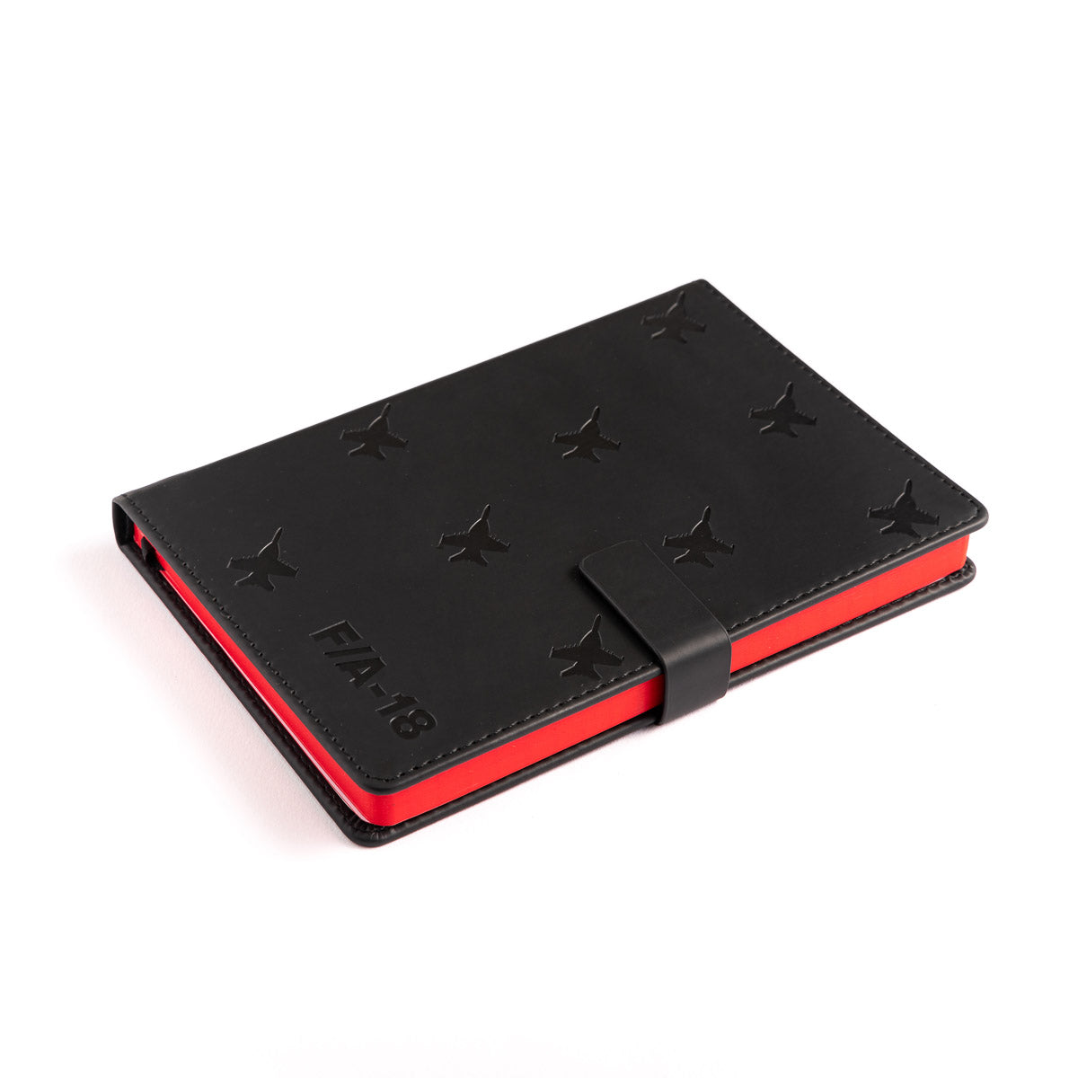 This closed black PU hardcover notebook from The Boeing Store features a vibrant red interior, embossed star patterns, and a strap closure. The FIFA 18 text is elegantly embossed near the bottom left corner, adding sleekness reminiscent of the Boeing F/A-18 Super Hornet Notebook.