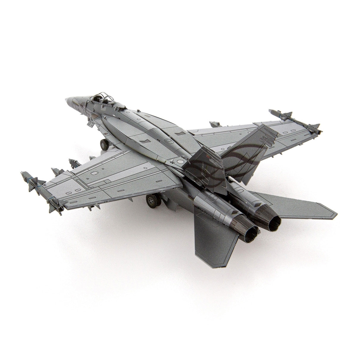 The Boeing Store’s Metal Earth Boeing F/A-18 Super Hornet is a gray twin-engine model with swept wings and missiles, viewed from the rear left. This U.S. Navy tactical jet is displayed against a white background.