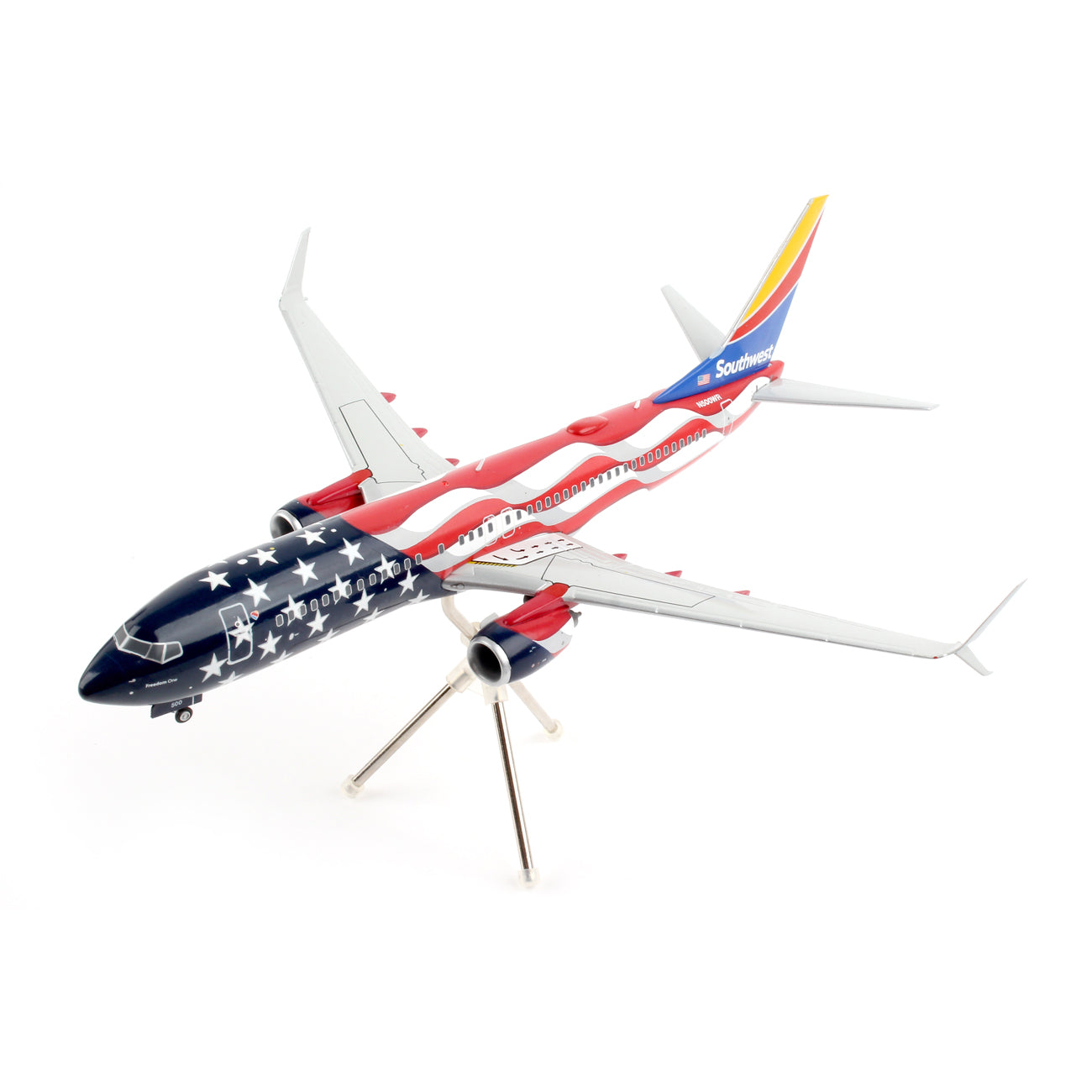 The Daron Southwest Airlines Boeing 737-800 Freedom 1:200 Model highlights an American flag design with stars and stripes on the body and tail, complemented by white wings, elegantly displayed on a three-legged stand.