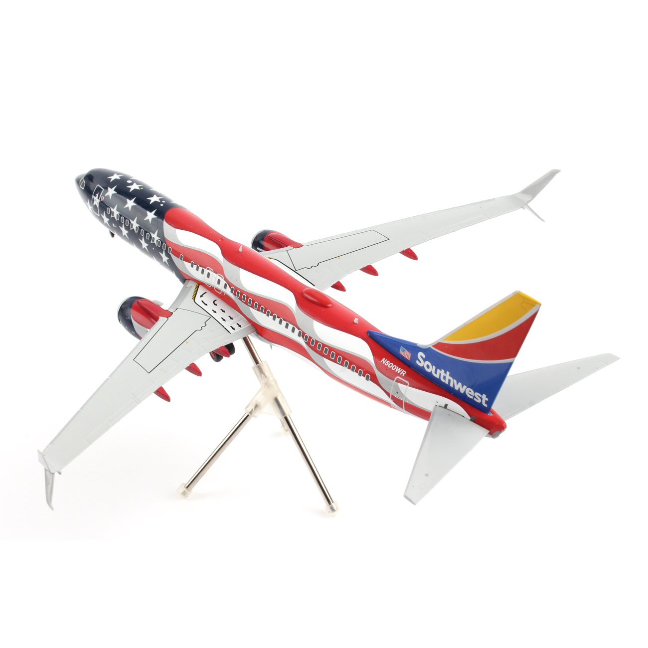 The Daron Southwest Airlines Boeing 737-800 Freedom 1:200 die-cast model showcases a patriotic American flag design on its fuselage and wings, featuring branded southwest Airlines tail design. It comes with a stand, detailed landing gear, and a star-spangled pattern, enhancing its allure.