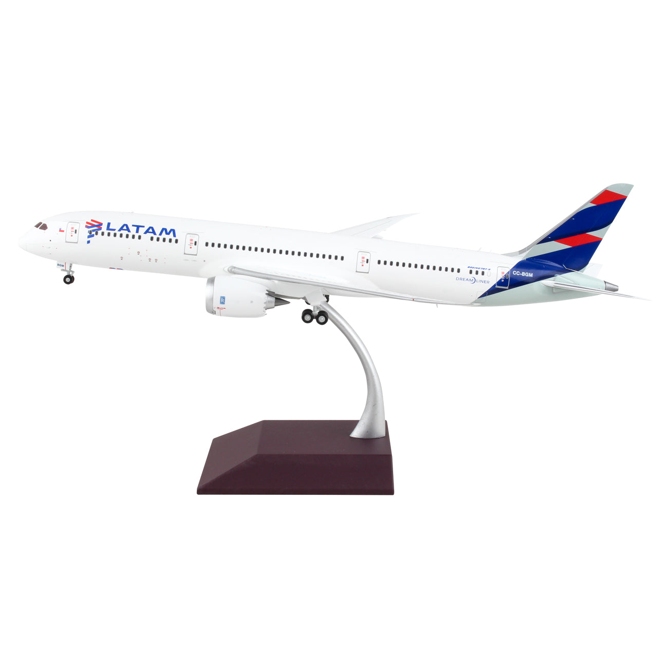 The Daron LATAM Airlines Boeing 787-9 1:200 die-cast model features white fuselage, blue/red/purple tail markings, LATAM branding, and is displayed on a curved stand with brown base.