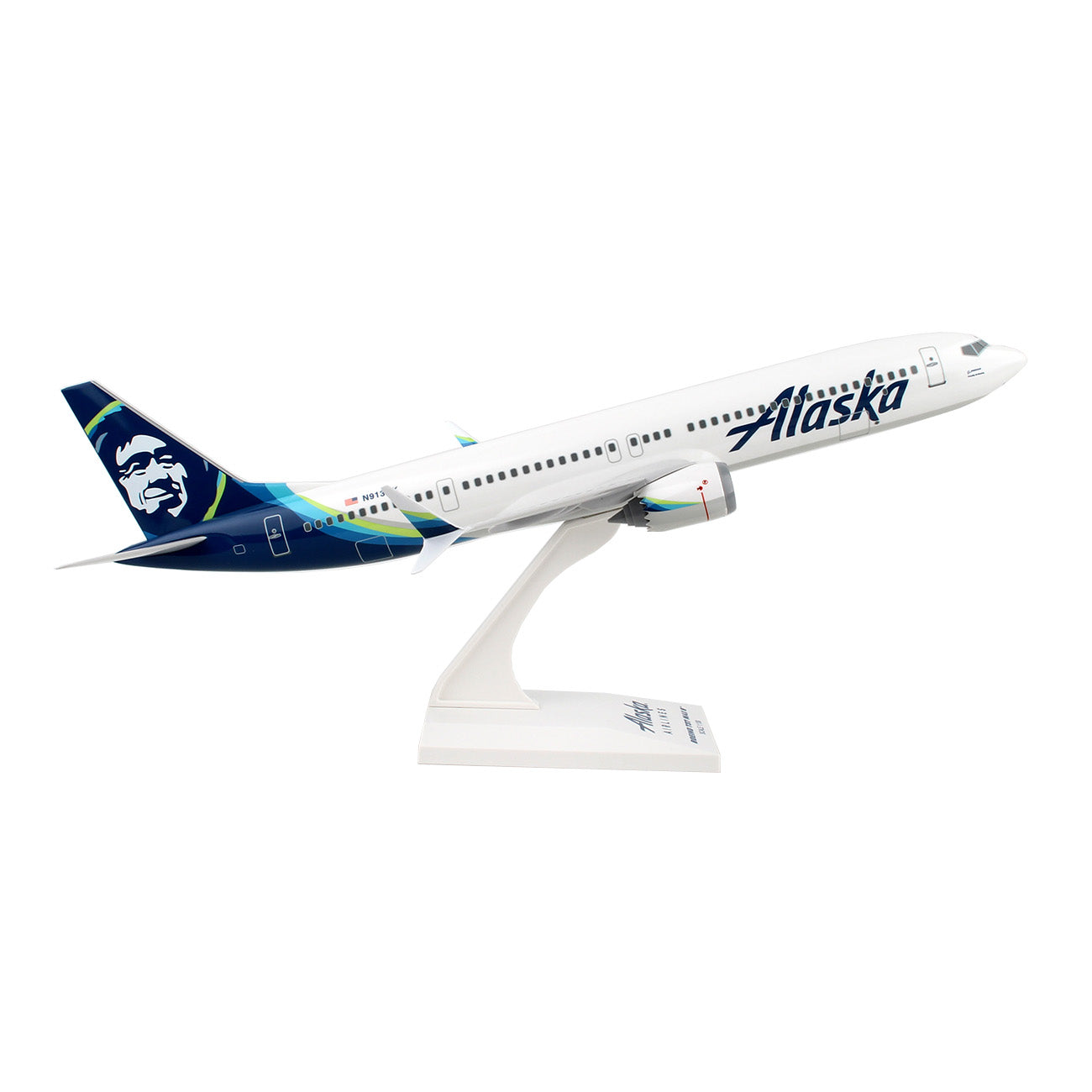 Collectors will love the Daron Alaska Airlines Boeing 737 MAX 9 1:130 Model on a stand, showcasing its white fuselage and blue tail with Indigenous-inspired design in a climbing pose.