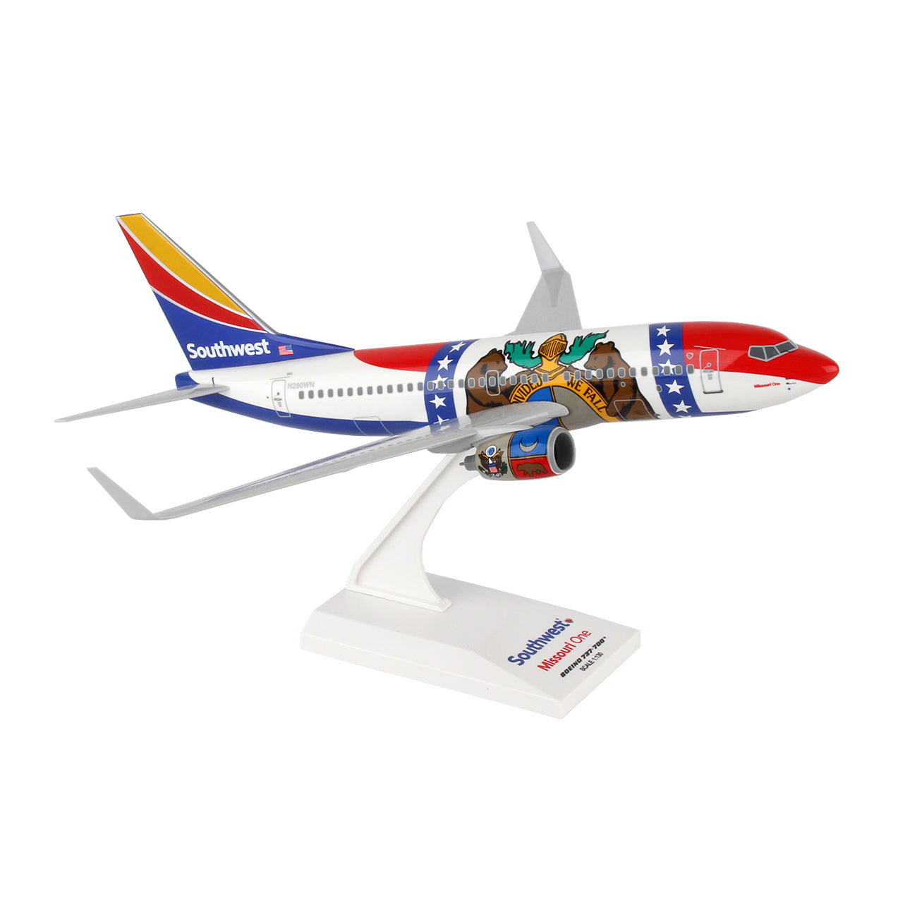 The Daron Southwest Airlines Boeing 737-700 Missouri One model sits on a stand, displaying vibrant livery with a bear and star design, Southwest branding, and colors of red, blue, yellow, and white.